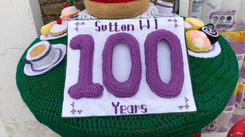 Colourful post box topper, celebrating the centenary of the Sutton WI