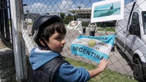 AFP Banners and Argentine flags with message in support of submarine crew members are displayed outside Argentina's Navy base in Mar del Plata, on the Atlantic coast south of Buenos Aires, on November 19,
