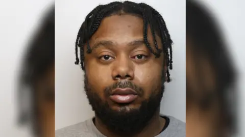 Chaivaz Stapleton police custody mugshot - he has a beard and grey t-shirt