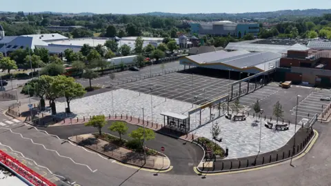 City of Wolverhampton Council A aerial view of the new-look Bilston outdoor market. The photo includes a large canopy, car park spaces and a road. 
