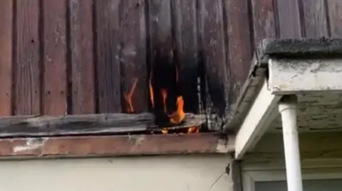 Burning cladding on the outside of a house. 