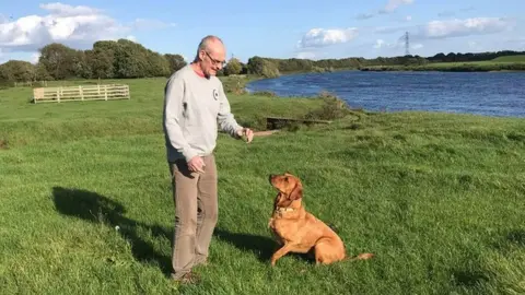 NHS Simon Bell with dog Rufus