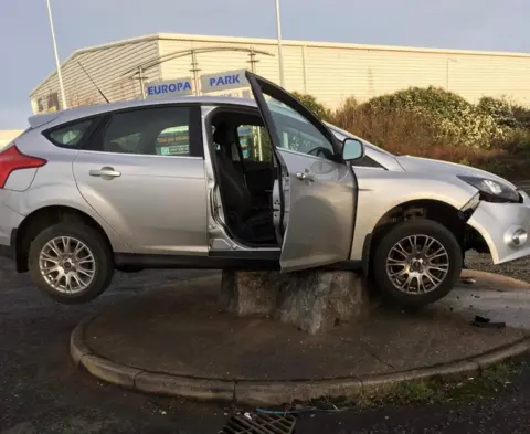 Grimsby News and Pictures Agency Car on top of a rock on a mini roundabout