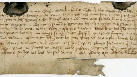 An old written document on brown paper.