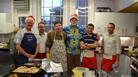 Simon Thompson Simon Thompson with several of the volunteers at a previous Hadleigh Christmas Present Trust event