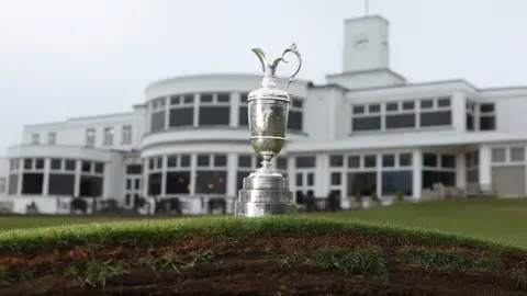 The Claret Jug photographed on top of a bunker in front of the Royal Birkdale clubhouse