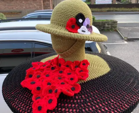 Alison Davis  Alison's topper to mark remembrance featuring a soldier with a helmet on