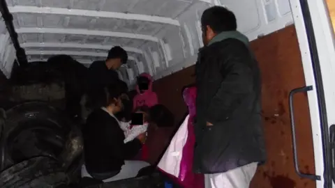 Home Office Migrants stood in the van after being found