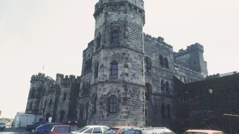 BBC / Richard Sowersby A castellated Victorian building with cars parked outside