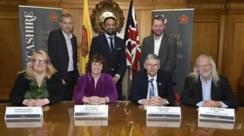 Lancashire Combined County Authority An image of the leaders involved in the new authority, smiling alongside their name-plates.