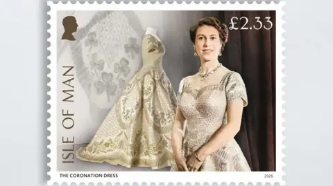 IOMPO/ROYAL COLLECTION A stamp featuring the Queen alongside the Coronation Dress which is ivory and champagne coloured with a large skirt and embellished.