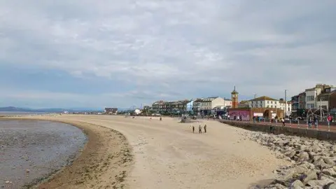 Stephen Armstrong/Geograph Morecambe beach and town - the sea on the left and a beach with the prom and buildings on the right 