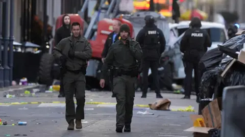 Emergency services on the scene of the attack on Bourbon Street. Wrecked truck can be seen in background. 