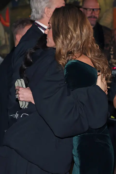 PA Media Jessie J and the Princess of Wales hugging - Catherine has her eyes closed as she embraces the singer 