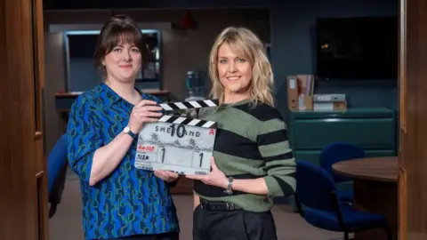 Alison O'Donnell and Ashley Jenson holding a clapper board which says Shetland on it.