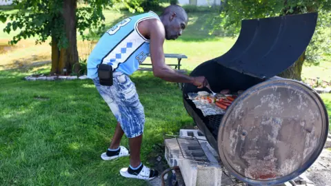 A man uses a grill to make food