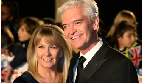 Reuters Television presenter Phillip Schofield arrives with his wife Stephanie Lowe for the Pride of Britain Awards in London, Britain October 30, 2017