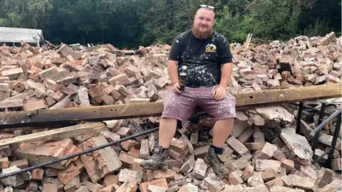 BBC Former landlord Tom Catton having a last drink in the rubble