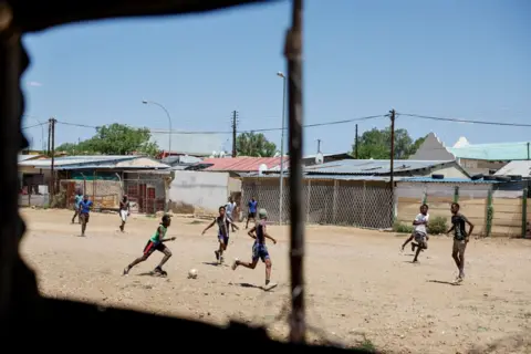 Simon Maina/AFP Men play   shot   connected  a makeshift tract  successful  Windhoek 