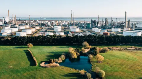 Getty Images Fawley refinery taken from (what appears to be) a drone, with a football pitch and park next to it pictured 