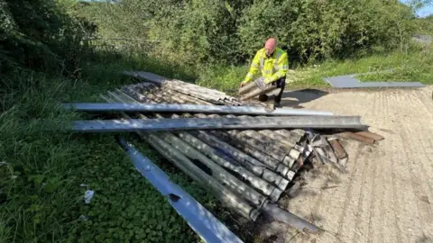 Steve Hubbard/BBC Ben Wilkin, enforcement officer at a fly-tip site at Caxton Gibbet