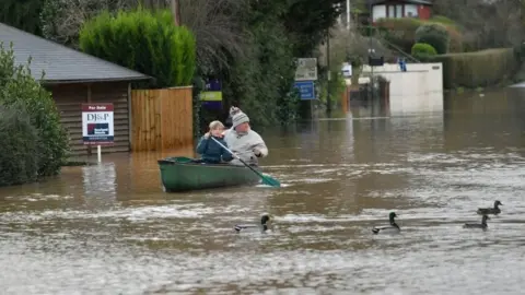 PA Media Residents in Monmouth used canoes to reach Lidl