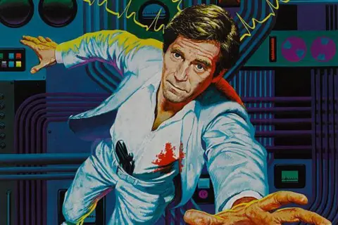 Getty Images A poster for The Terminal Man. George Segal is in a white suit with blood splatter on his shirt and a gun tucked into his belt. He is floating, and sparks of electricity are behind him.