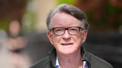 PA Lord Mandelson in glasses and grey jacket