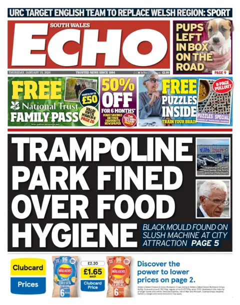 South Wales Echo Front page of the South Wales Echo with the main headline: "Trampoline park fined over food hygiene", with an image of the man and the trampoline park. Above is an advert for a free National Trust family pass, next to that an advert for 50% off papers for six months, and then next to that is an advert saying free puzzles inside. Above is a picture of a dog with the headline "pups left in box on the road." 