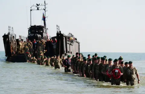 Aaron Chown/PA A beach landing by the Royal Marines of 47 Commando at Asnelles before their annual 'yomp' to Port-en-Bessin, in Normandy, France, to commemorate the 80th anniversary of the D-Day landings. Picture date: Thursday June 6, 2024. PA Photo. See PA story MEMORIAL DDay. Photo credit should read: Aaron Chown/PA Wire