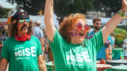 Oxfam Longtime Oxfam campaigners, Alan Shaw and Summer Dean, enjoy a sing and a dance at Glastonbury 2023