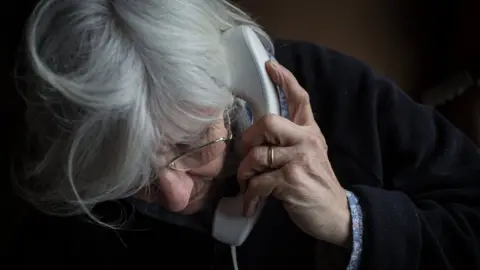 Getty Images An elderly woman on the phone