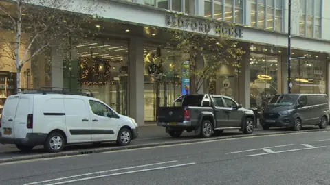 Vehicles parked on the pavement on Bedford Street in Belfast city centre