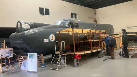 Photograph of the Avro Shackleton maritime patrol aircraft. The image is taken inside a storage warehouse.