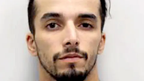 Metropolitan Police A police custody image of Brahim Kaddour-Cherif, a young, slim man of Middle Eastern appearance, with some facial hair,