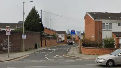 The entrance to a close of terraced and semi-detached houses