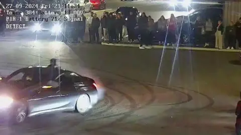 Nottinghamshire Police An image of a driver performing a "donut" at a retail park in Colwick