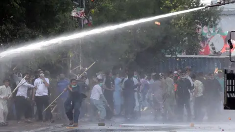 EPA Police use a water cannon during clashes with supporters of Pakistan's former Prime Minister Imran Khan at a protest against his arrest, in Lahore, Pakistan, 09 May 2023.