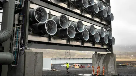 Getty Images A bank of fans pulls air through specialized filters at Climeworks' Mammoth carbon removal plant