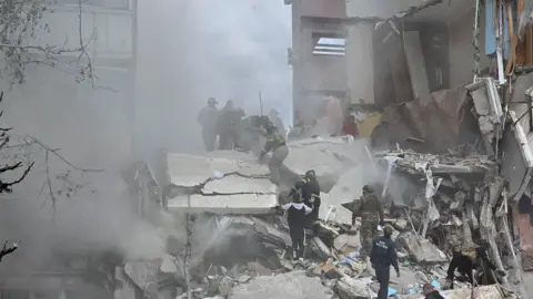 Reuters Firemen search rubble