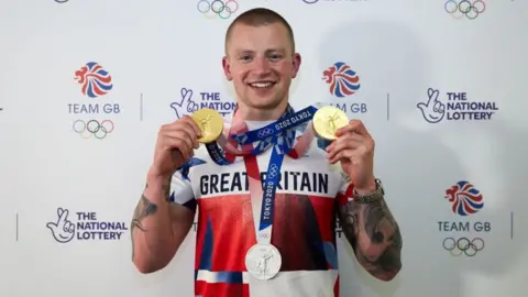 Getty Images Adam Peaty with gold medals