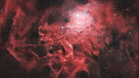 Lee Pullen/UrbanAstrophotography.com The Flaming Star Nebula is a ball of bright red gasses with a very bright white centre point. 