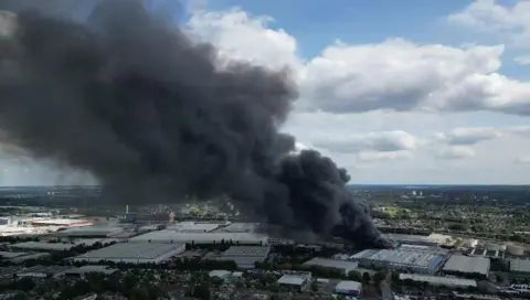 Dave Wallis Drone footage showing plumes of black smoke rising above the Birmingham skyline, near the oil terminal