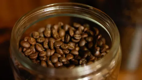 Shutterstock Coffee beans in a jar