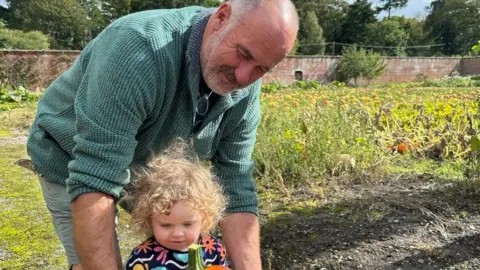 Phil Handley with his granddaughter