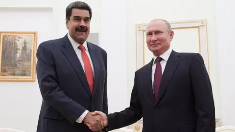 EPA Russian President Vladimir Putin (R) and Venezuelan President Nicolas Maduro (L) shake hands during their meeting in the Kremlin