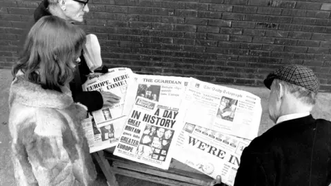 Getty Images People read newspapers declaring news of British entry into the EEC