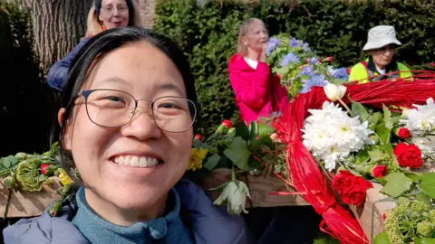 Pilgrim Cross A woman smiling at the camera on a walk in 2023