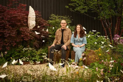 Alister Thorpe Joe and Laura Carey in their garden at the Chelsea Flower Show