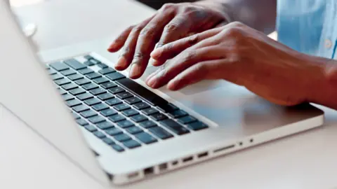 Getty Images Man typing on macbook